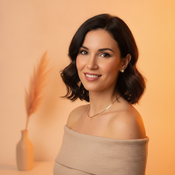 Portrait of Margaux Fontaine, an elegant woman in a soft beige top, smiling confidently with a warm amber-tinted background.